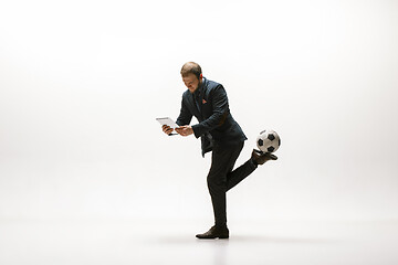 Image showing Businessman with football ball in office