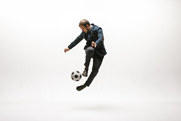 Image showing Businessman with football ball in office