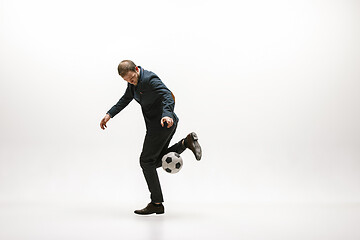 Image showing Businessman with football ball in office