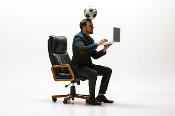 Image showing Businessman with football ball in office