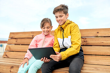 Image showing children with tablet computer sitting on bench