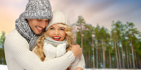 Image showing couple hugging over winter forest background