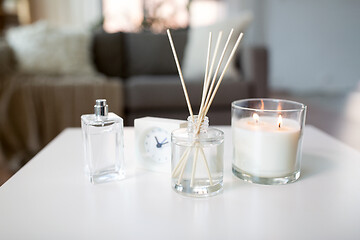 Image showing aroma reed diffuser, burning candle and perfume