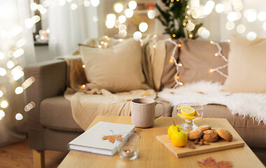 Image showing tea with lemon, book and cookies on table at home