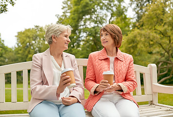 Image showing senior women or friends drinking coffee at park