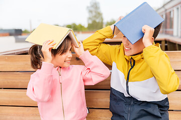 Image showing school children with books having fun outdoors