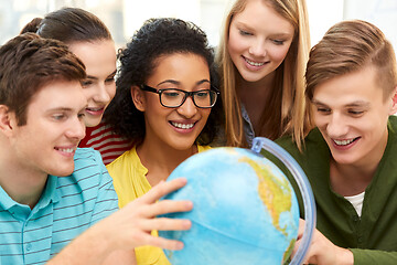 Image showing happy high school students looking at earth globe