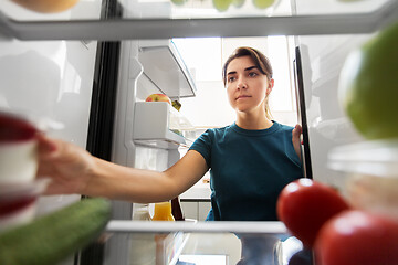 Image showing woman taking food from fridge at home