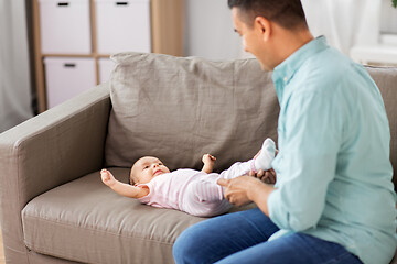 Image showing middle aged father playing with baby at home