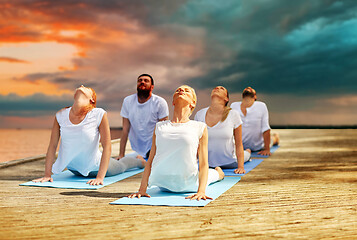 Image showing group of people making yoga exercises outdoors