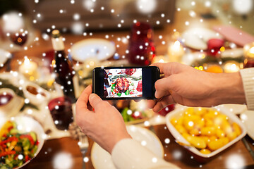 Image showing hands photographing food at christmas dinner