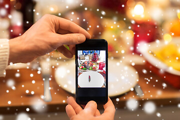 Image showing hands photographing food at christmas dinner