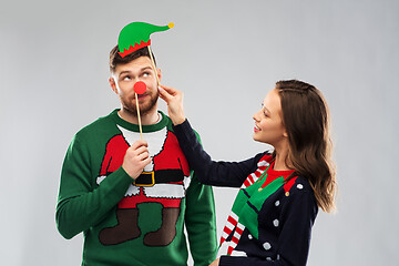 Image showing couple with christmas party props in ugly sweaters