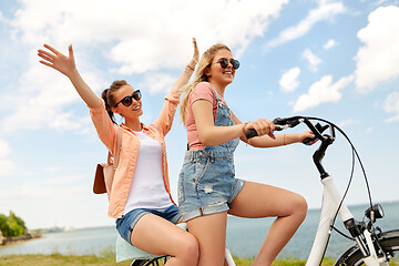 Image showing teenage girls or friends riding bicycle in summer