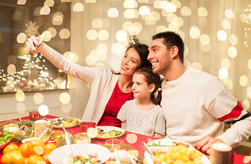 Image showing happy family taking selfie at christmas dinner