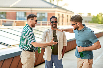 Image showing happy male friends drinking beer at rooftop party