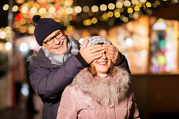 Image showing happy senior couple at christmas market