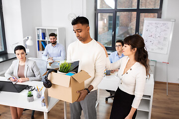 Image showing colleague seeing off sad fired male office worker