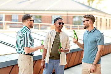 Image showing happy male friends drinking beer at rooftop party