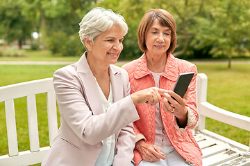 Image showing happy senior women with smartphone at summer park