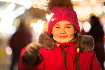 Image showing happy girl with sparkler at christmas market