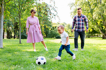 Image showing happy family playing soccer at summer park