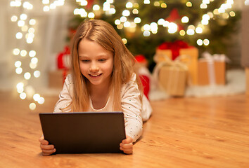 Image showing smiling girl with tablet pc at christmas home