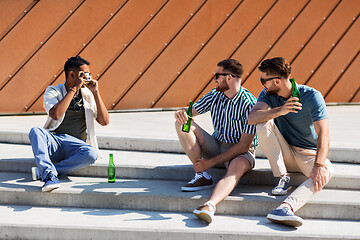 Image showing man photographing friends drinking beer on street