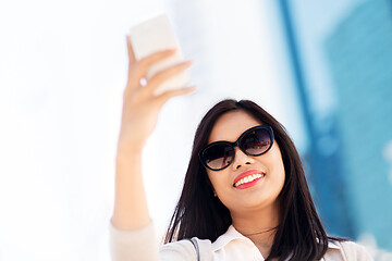 Image showing asian woman taking selfie by smartphone in city