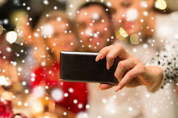 Image showing close up of friends taking selfie on christmas