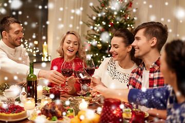 Image showing friends celebrating christmas and drinking wine