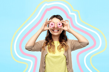 Image showing happy asian woman with eyes of donuts