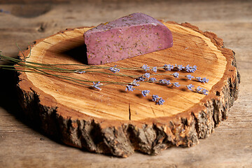 Image showing Lavender cheese with bunch of fresh lavender flowers on rough wooden planks