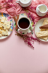 Image showing Hot chocolate or cocoa in cup with various sweets on sides. White chocolate bar and biscuits