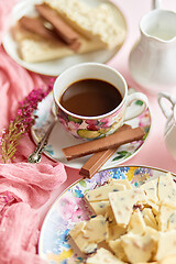 Image showing Delicious dessert on pink background. Hot coffee or dark chocolate with white chocolate