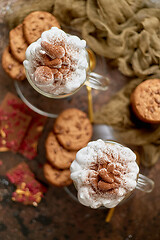 Image showing Sweet dessert served. Hot chocolate with whipped cream on top and cookies