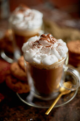 Image showing Two tall glasses with hot chocolate, whipped cream and cinnamon powder on top