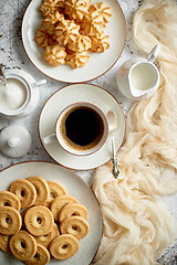 Image showing Sweet dessert concept. Golden crunchy cookies served with cup of black coffee