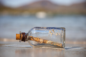 Image showing Message in the bottle against the Sun setting down