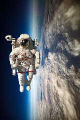 Image showing Astronaut in outer space against the backdrop of the planet eart