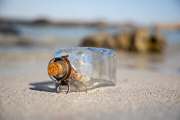 Image showing Message in the bottle against the Sun setting down