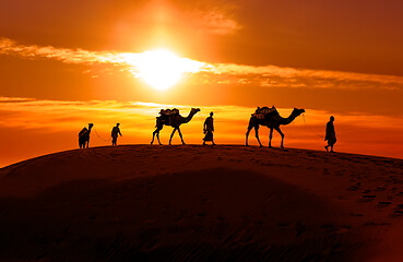 Image showing Cameleers, camel Drivers at sunset. Thar desert on sunset Jaisal