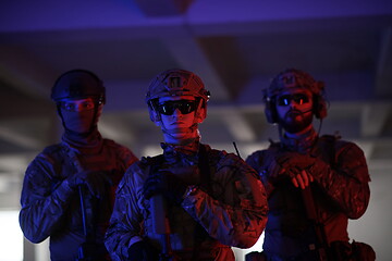 Image showing soldier squad team portrait in urban environment colored lightis