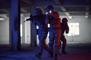 Image showing Soldiers squad in tactical formation having action urban environment