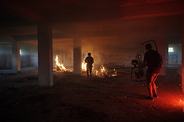 Image showing Videographer Taking Action Shoot of Soldiers in Action urban environment