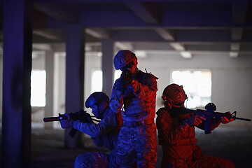 Image showing Soldiers squad in tactical formation having action urban environment