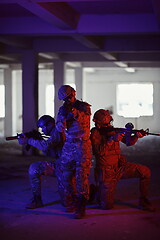 Image showing Soldiers squad in tactical formation having action urban environment