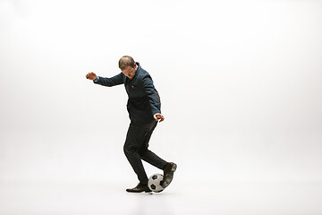 Image showing Businessman with football ball in office