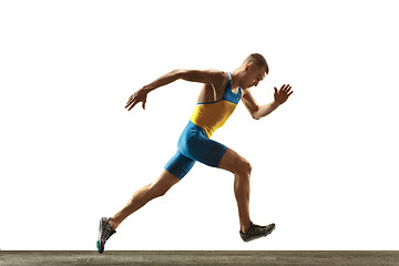 Image showing Young caucasian man running or jogging isolated on white studio background.