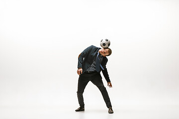 Image showing Businessman with football ball in office